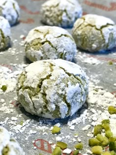 there are several cookies that have been covered in powdered sugar and pistachio