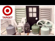 there are many vases and jars on the shelf in front of the target sign