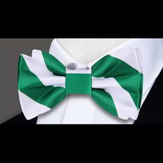 Radiant Elegance: Green and White Block Stripe Silk Bow Tie In the realm of sartorial refinement, the bow tie stands as an emblem of sophistication and flair. Our Green and White Block Stripe Silk Bow Tie invites you to embrace a fresh and vibrant aesthetic, effortlessly blending modernity with timeless elegance. Dive into the details of this exquisite accessory, exploring its design, customization options, and ideal pairings with dress shirts and suits, as well as the events where it shines the White Classic Bow Tie, Classic White Bow For Formal Occasions, Classic White Standard Tie Bow, Elegant Green Bow Tie And Suit Accessories, Elegant Green Suit And Tie Accessories With Bow, Elegant Green Tie With Satin Bow, Classic White Bow Ties, Classic White Bow With Ties, Formal Summer Bow Tie With Ribbon