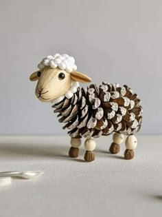 a toy sheep made out of pine cones