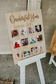 a wooden sign with photos on it sitting in front of a wall next to a chair