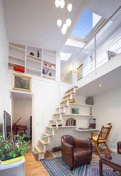 a living room filled with furniture and a stair case