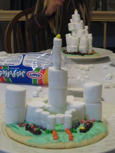 there is a cake made to look like a castle on top of marshmallows