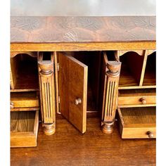 an antique wooden desk with drawers and shelves