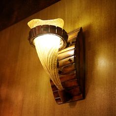 a light fixture mounted on the side of a wooden wall