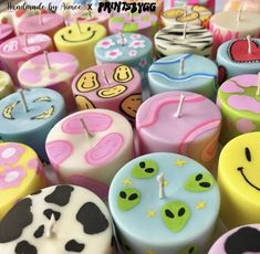 many different colored candles with faces and numbers on them, all decorated in the same style