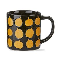 a black and yellow coffee mug with pumpkins on it