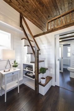 there is a wooden stair case in the room with white walls and wood flooring