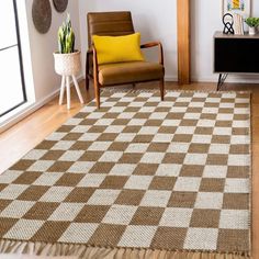 a brown and white rug sitting on top of a wooden floor next to a chair