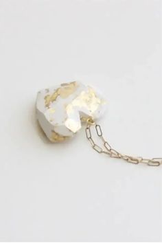 White and gold marble pendant on a gold chain. Aesthetic Options