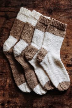 five pairs of socks sitting on top of a wooden table