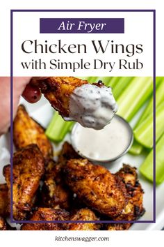 air fryer chicken wings with simple dry rub recipe on a white plate topped with ranch dressing and celery sticks