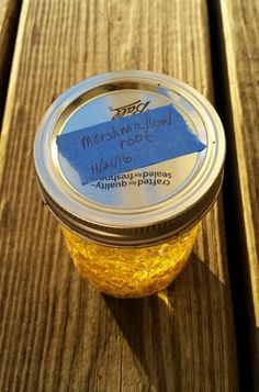 a jar of marmalade sitting on top of a wooden table