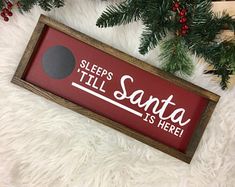 a wooden sign that says sleep's til santa is here