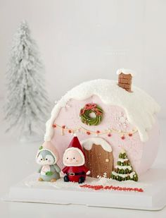 a christmas scene with a pink house and two gnomes