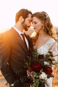 a bride and groom standing together in the desert