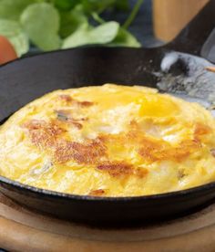 an omelet in a cast iron skillet on a table