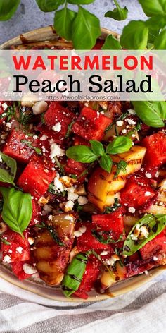 watermelon, peach and feta salad in a bowl with basil leaves on top