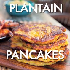 a stack of pancakes sitting on top of a wooden cutting board