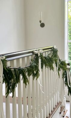 the garland is hanging on the bannister rail