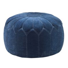 a blue velvet poufle with an intricate design on the top and bottom, sitting in front of a white background