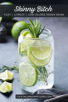 a glass filled with water and lime slices