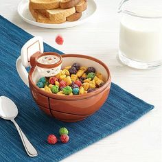 a bowl filled with cereal sitting on top of a blue place mat