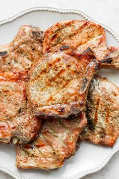 grilled pork chops on a white plate