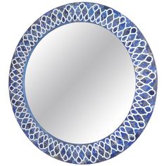 a blue and white circular mirror with an intricate design