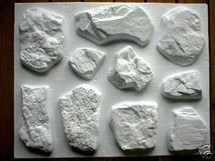 several pieces of white clay sitting on top of a wooden table