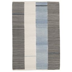 a rug with black and white stripes on the bottom, in different shades of grey