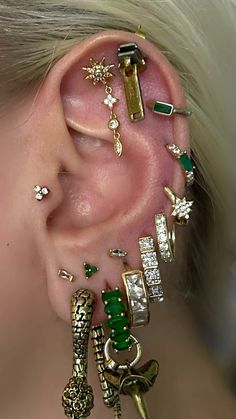 an ear with many different types of jewelry on it