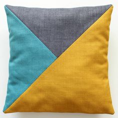 a blue and yellow pillow on a white surface