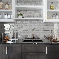 a kitchen with gray cabinets and marble counter tops, white shelves above the sink are filled with liquor bottles