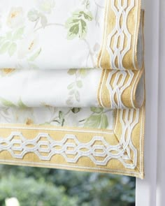 an open window with yellow and white curtains