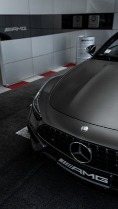 the front end of a mercedes car parked in a garage