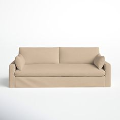 a beige couch sitting on top of a white floor