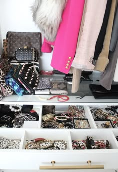 an organized closet with lots of purses and handbags