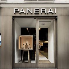 the entrance to a store with an open door that says panerai on it