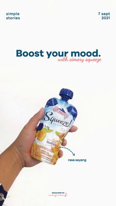 a hand holding a bottle of juice with the words boost your mood