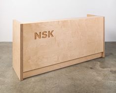 a wooden desk with the word nsk engraved on it's front and sides