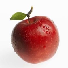 an apple with water drops on it and a green leaf sticking out of the top