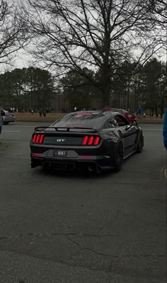 a black sports car parked in a parking lot