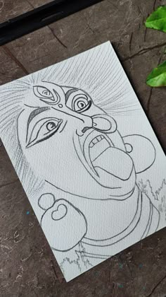 a drawing of a man with his mouth open and eyes wide open on a piece of paper