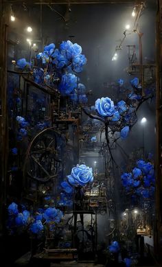 blue flowers are in the middle of a dark room with lights on it and an old machine