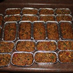 trays filled with food sitting on top of a wooden table next to each other