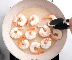 shrimp being cooked in a pan on the stove