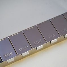 a close up of a metal object with writing on it's sides and four different colors