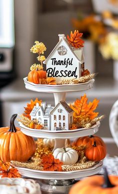 three tiered trays filled with pumpkins and gourds are stacked on top of each other