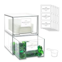 four clear boxes filled with green candies next to each other and labels on them